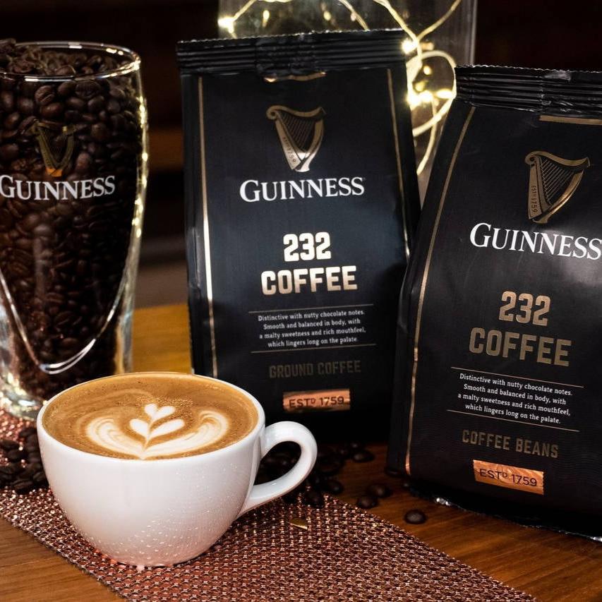 A cup of Guinness coffee and Guinness Coffee Beans 227g on a table.