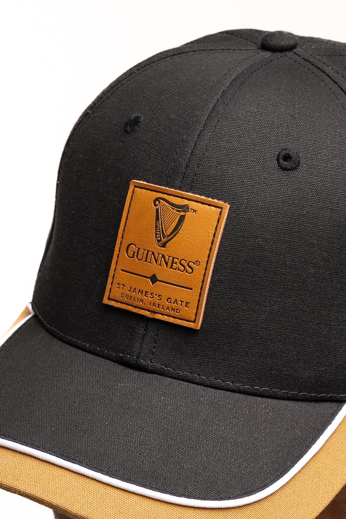 The Guinness Black Cap with Caramel Edge from Guinness Webstore UK features the iconic logo and "St. James's Gate, Dublin, Ireland"—a stylish nod to the legendary Irish drink.