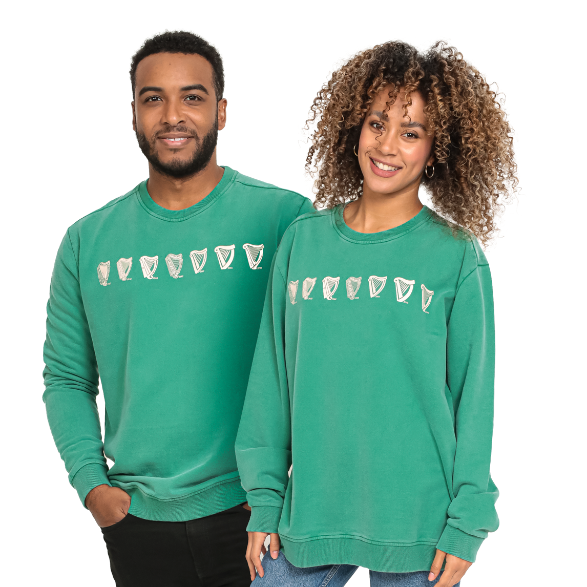 A man and woman wearing a Guinness Evolution Harp Green Sweatshirt, proudly showcasing their love for Guinness.