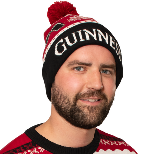 A sustainable man wearing an Official Guinness Christmas beanie from Guinness UK.