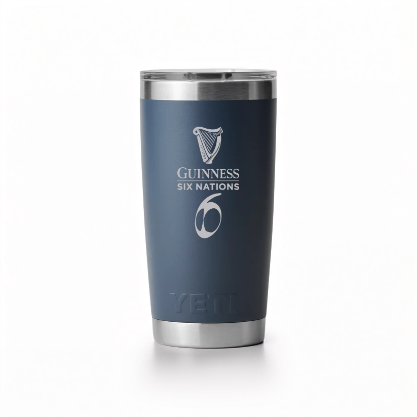 The Guinness Six Nations Yeti 20oz Tumbler in navy from Guinness Webstore UK features double-wall vacuum insulation, a stainless steel build, "YETI" branding at the base, and the tournament logo on its matte finish.