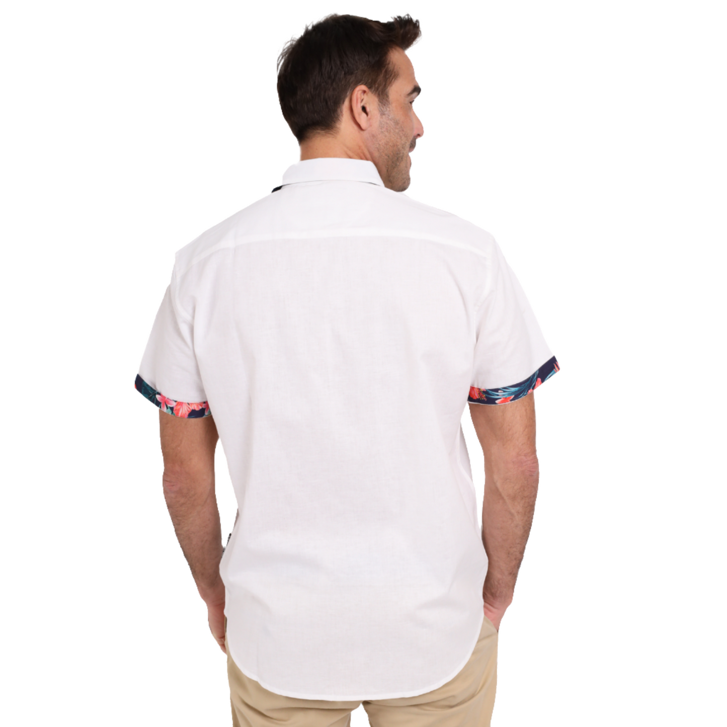 A man standing with his back to the camera, wearing a Guinness Webstore UK Guinness White Linen Summer Shirt with colorful trim on the sleeve cuffs and beige pants.