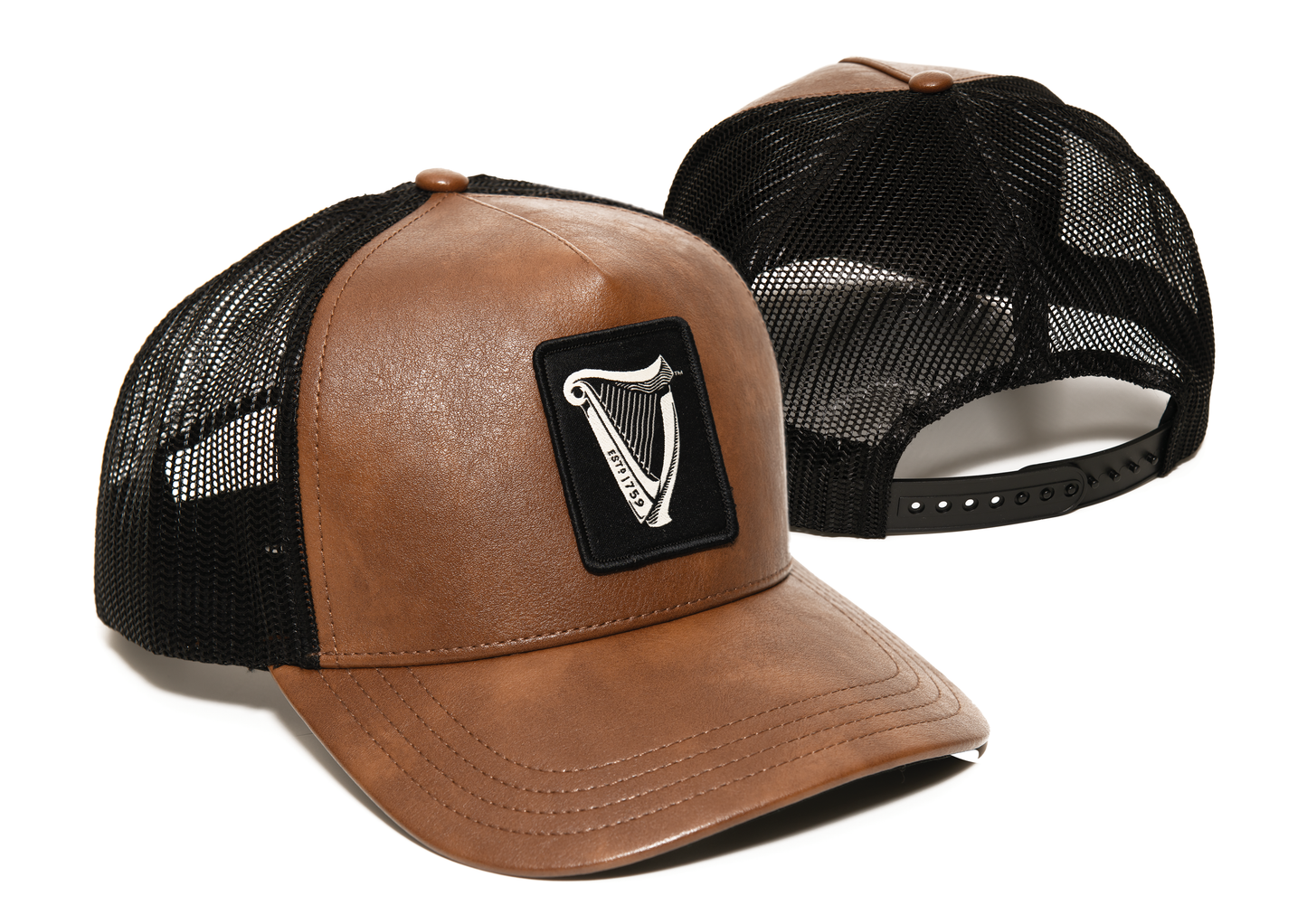 Two Guinness Brown Leather Trucker Caps from Guinness Webstore UK, featuring mesh backs, adjustable snap closures, and front panels with the iconic harp logo patch.