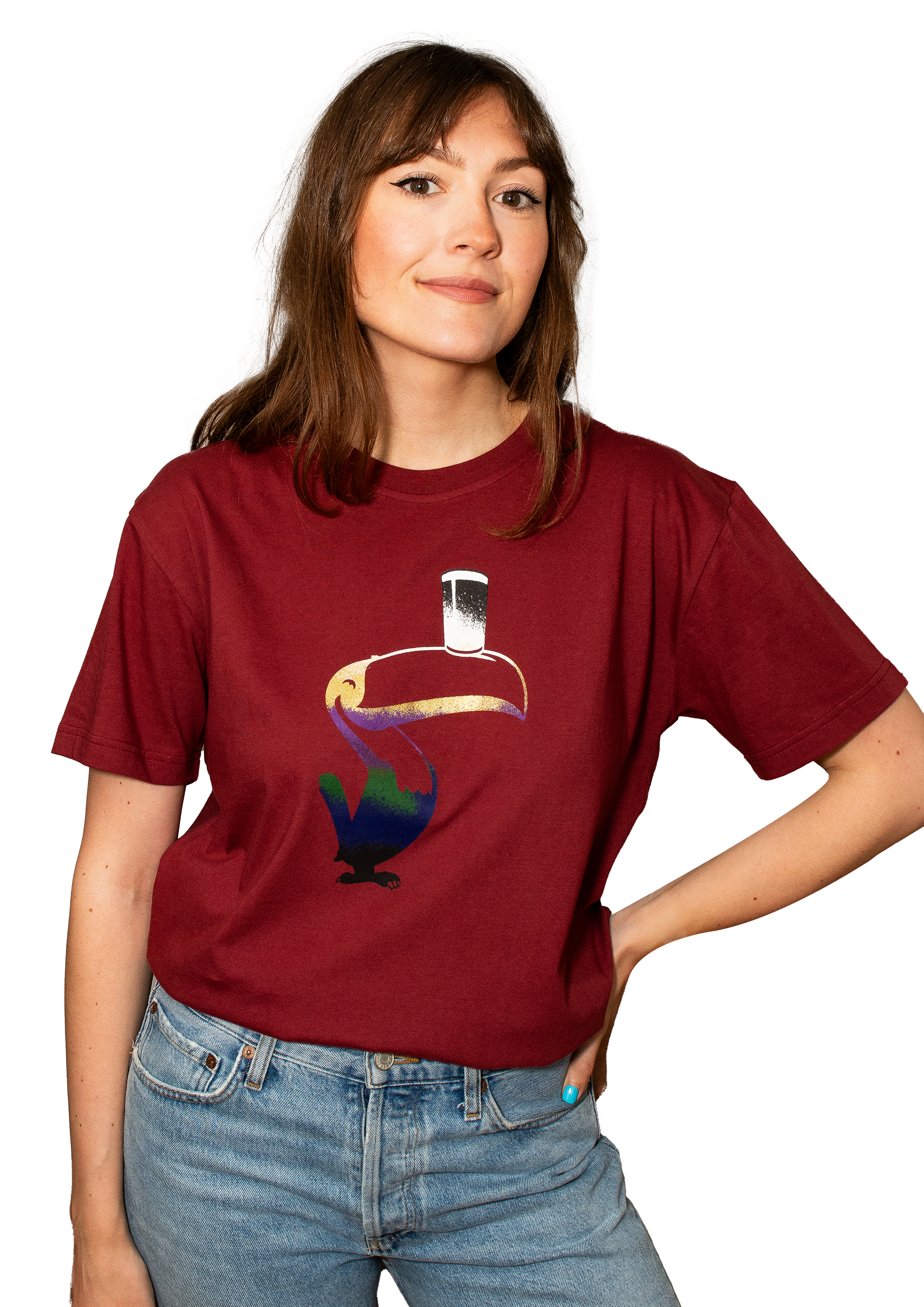 The individual, dressed in a red Guinness Liquid Toucan T-Shirt and jeans, stands against a white background, capturing the essence of the Guinness Liquid Toucan brand.