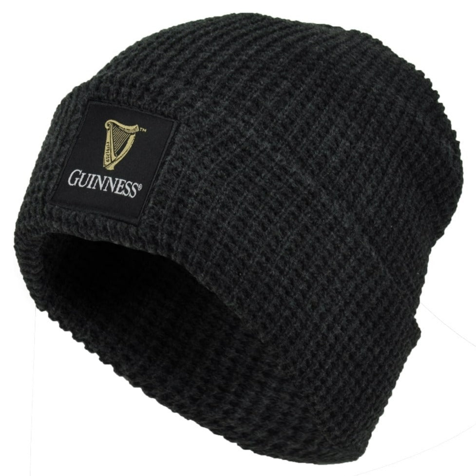 The Guinness UK Thermal Warm Beanie is a unisex black knit hat featuring a front patch with the classic Guinness logo and harp emblem.