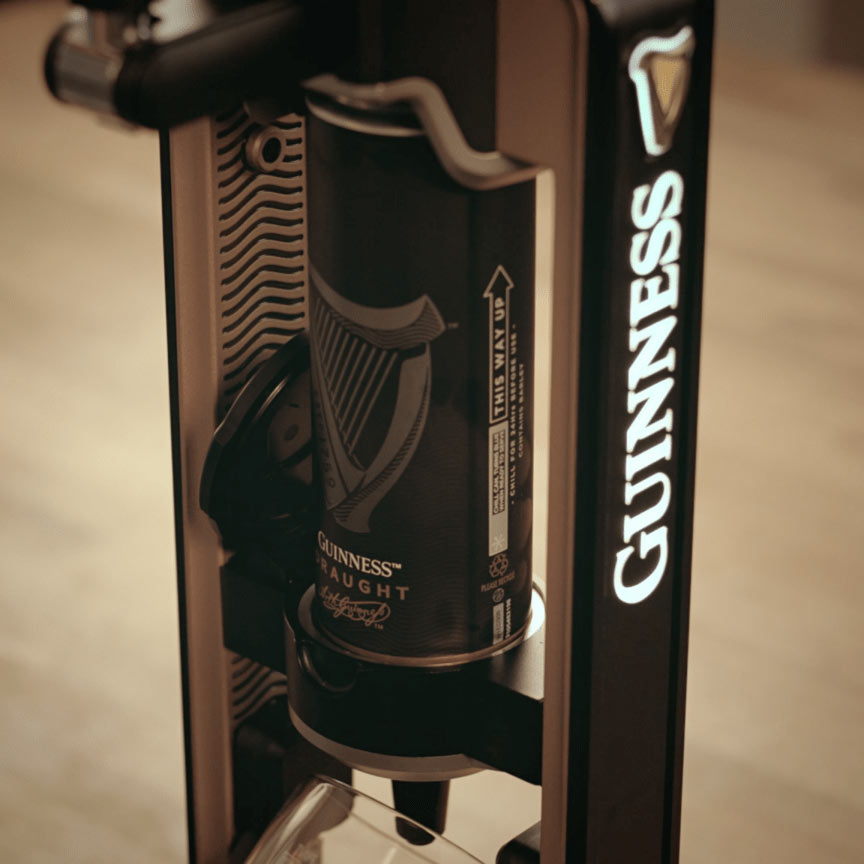 The Guinness UK MicroDraught, a home bar machine, is sitting on top of a table.