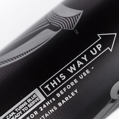 A black bottle of Guinness UK MicroDraught Stout Beer Cans – 24 x 558 ml with the words 'this way up' on it.
