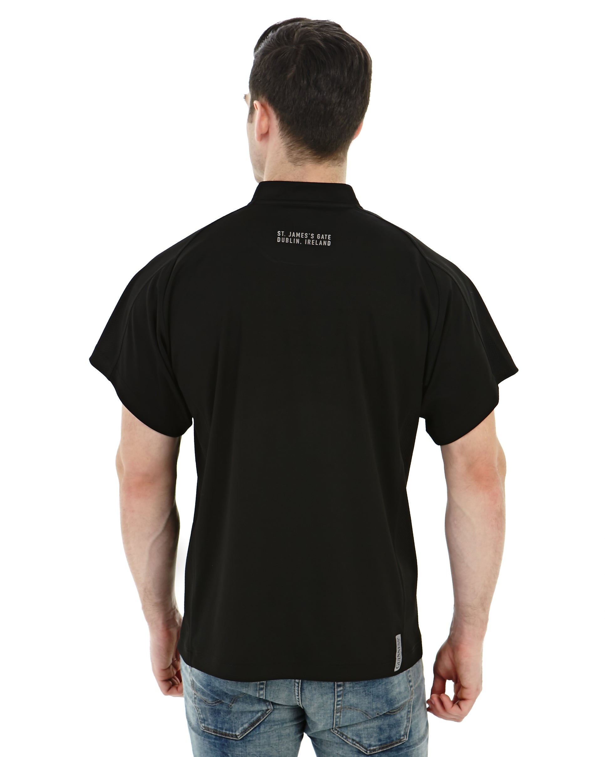 The back view of a man wearing a Guinness All Black Rugby Jersey.