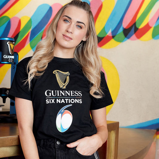 A woman donning a black Guinness UK Guinness Six Nations Black T Shirt.