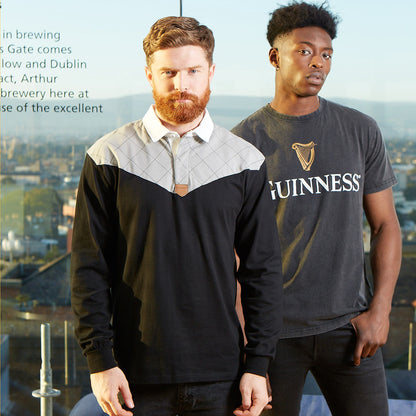 Two men standing next to each other wearing 100% cotton Guinness UK Heritage Charcoal Grey and Black Long Sleeve Rugby Jerseys.