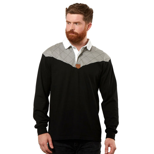 A man wearing a black and grey Guinness Heritage Charcoal Grey and Black Long Sleeve Rugby Jersey made of 100% cotton and designed with the iconic Guinness Heritage by Guinness UK.