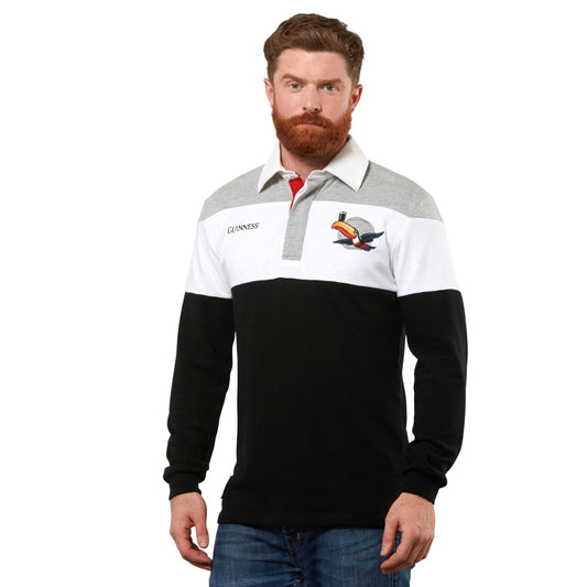 A man with a beard is wearing a Guinness UK Toucan Rugby Jersey.