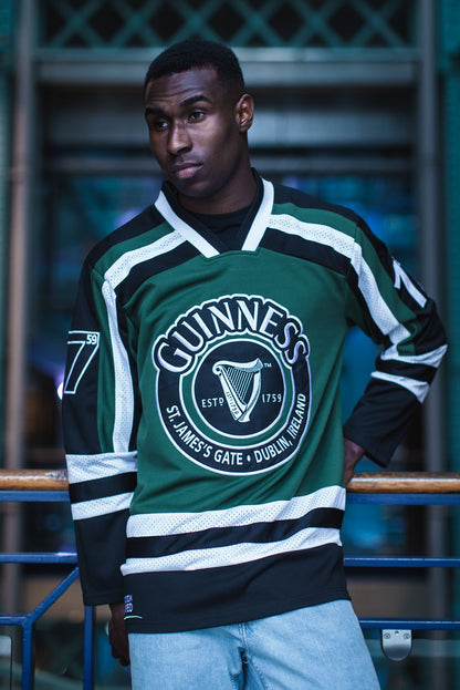 A man wearing a Guinness UK HARP hockey jersey.