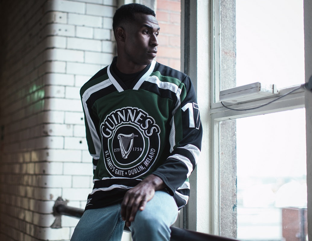 A young man sporting a HARP Hockey Jersey in green and black. (Guinness UK)