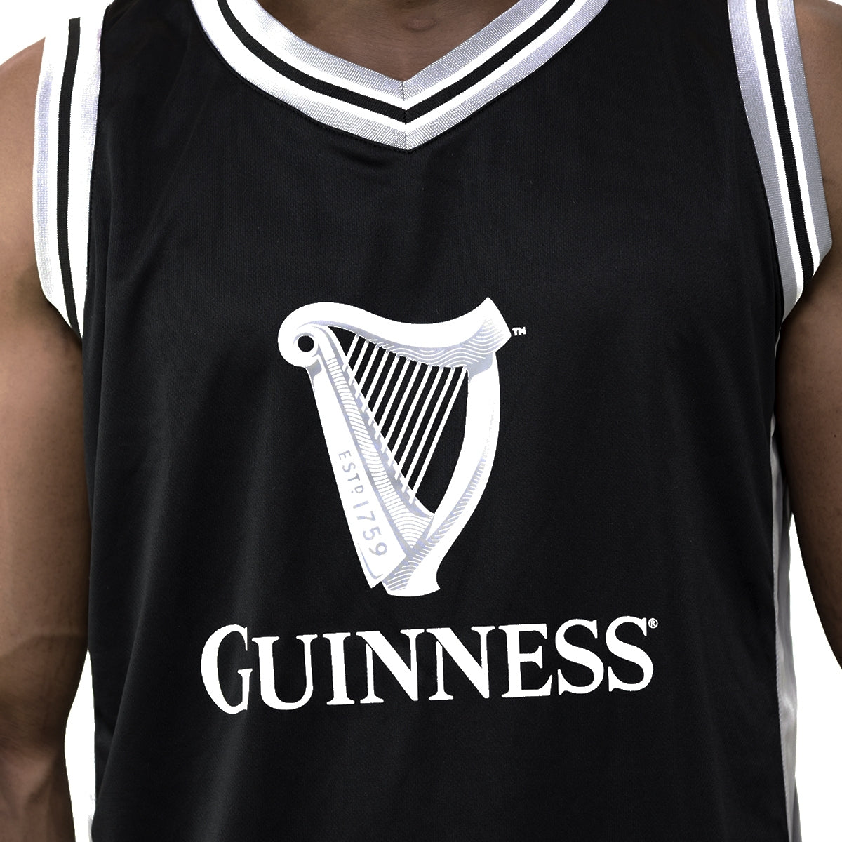 A basketball fan wearing a Guinness UK Black and Grey Basketball Jersey.