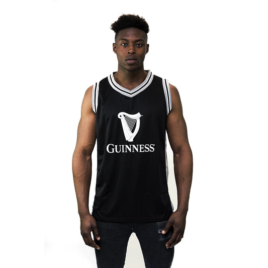 A basketball fan proudly wearing a black Guinness UK basketball jersey.
