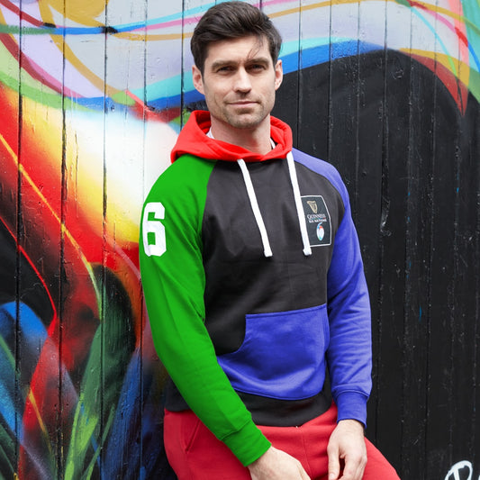 A man is leaning against a wall wearing a Guinness UK Six Nations Colour Block Hoodie.