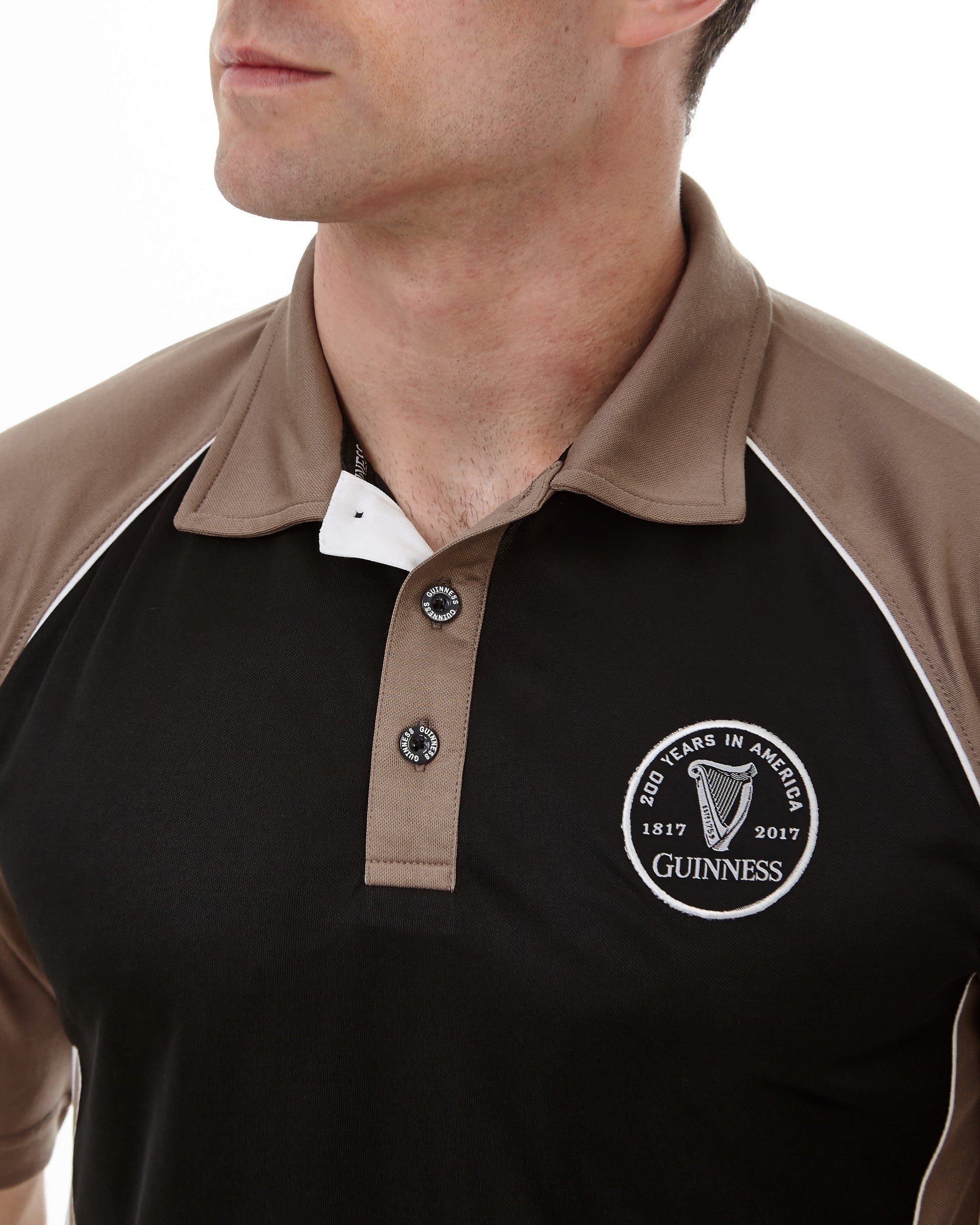 A man wearing a Guinness Performance Panelled Golf Shirt by Guinness UK.