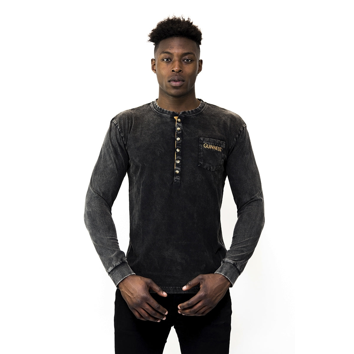 A man wearing a durable black Classic Henley t-shirt by Guinness UK.