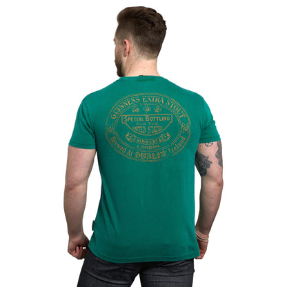 The back view of a man wearing a Guinness UK Green Guinness Harp Premium T-Shirt from Ireland.