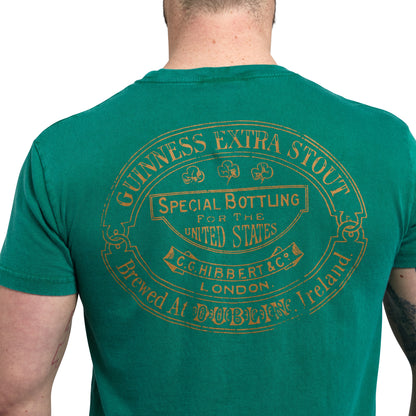 The back of a man wearing a green Guinness Harp Premium T-Shirt.