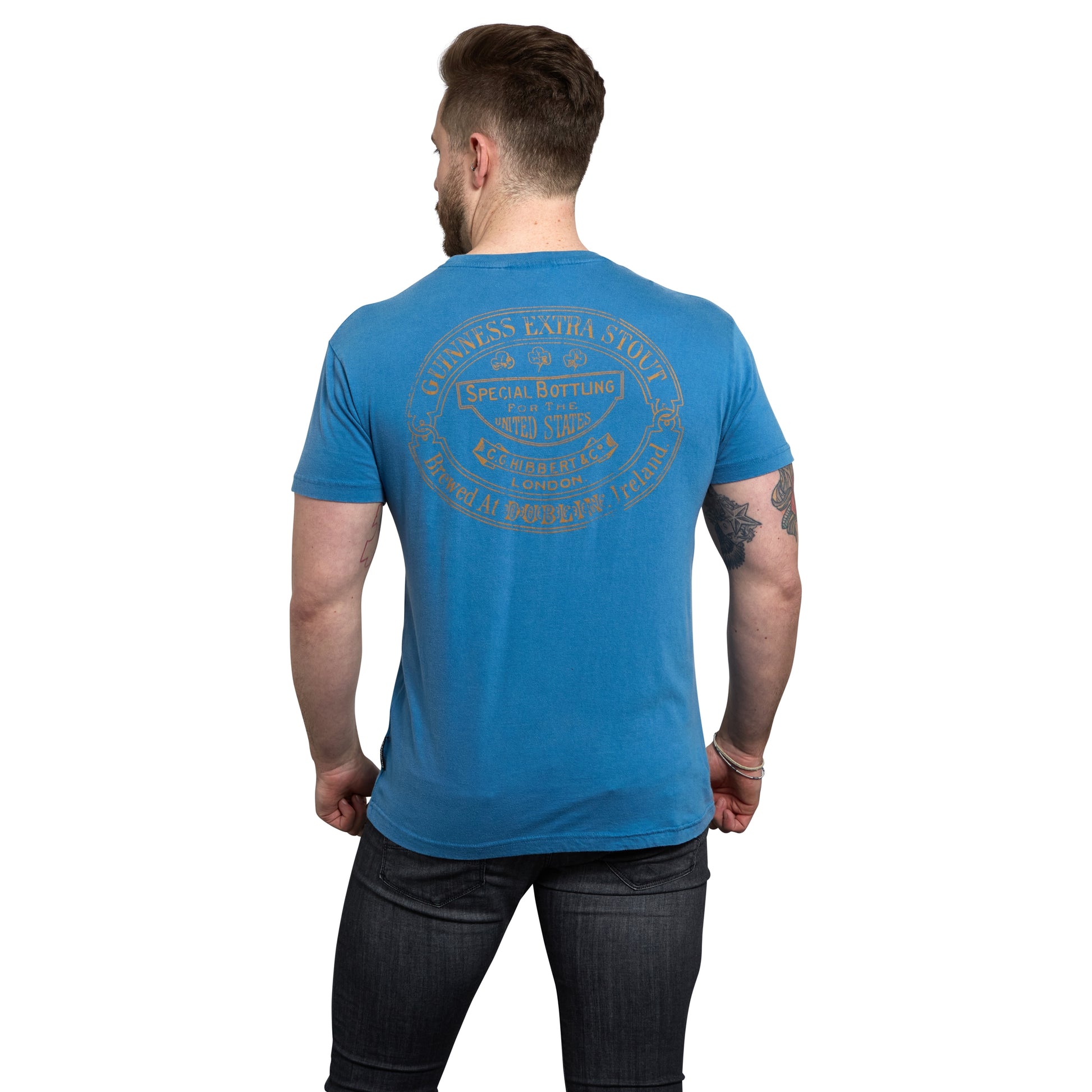 The back view of a man wearing a Sky Blue Guinness Harp Premium T-Shirt by Guinness UK.