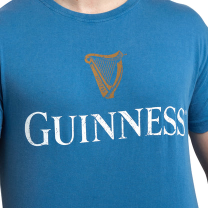 A man wearing a Sky Blue Guinness Harp Premium T-shirt made of cotton from Guinness UK.