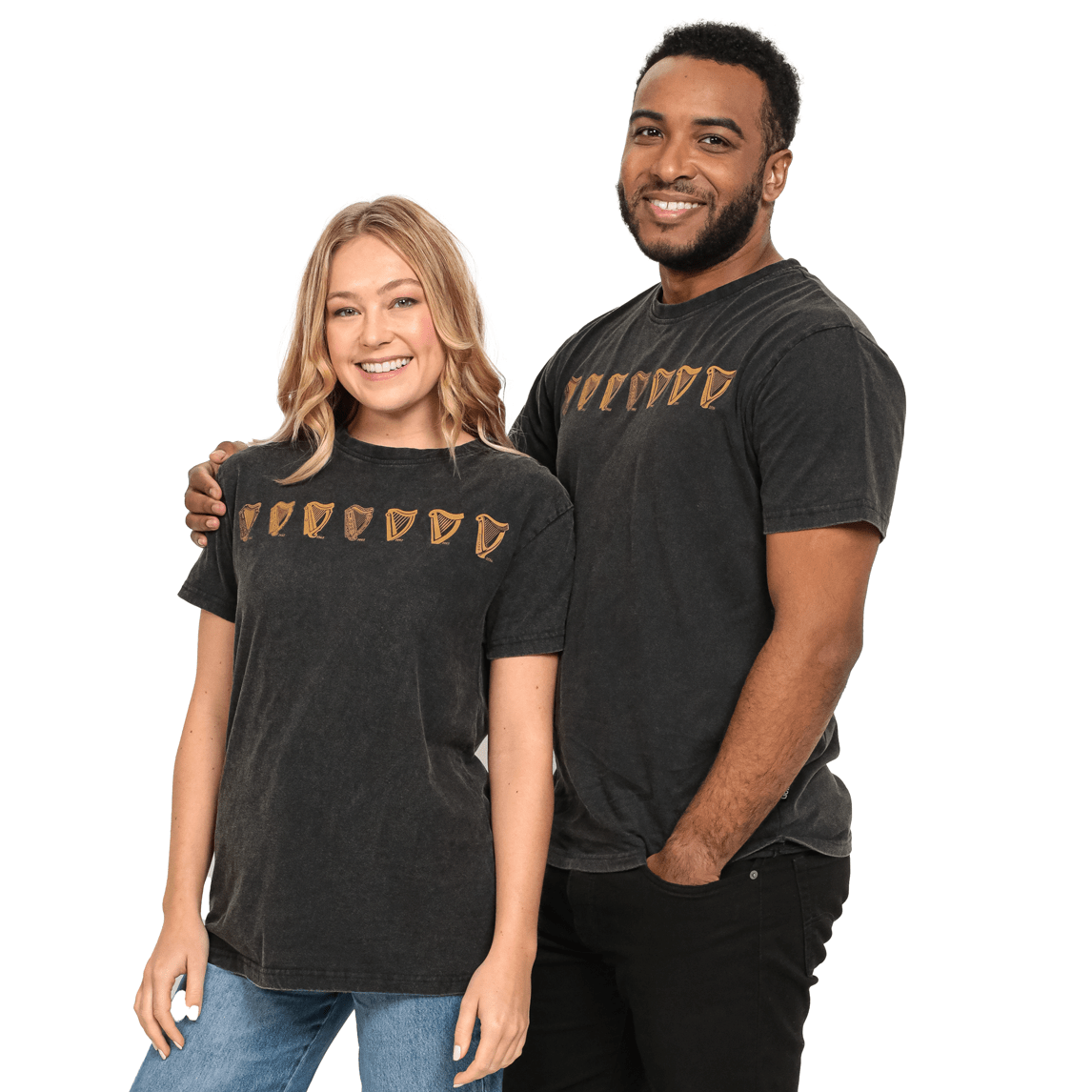 A man and woman standing next to each other wearing black Guinness UK® Evolution Harp Tee t-shirts made of cotton.