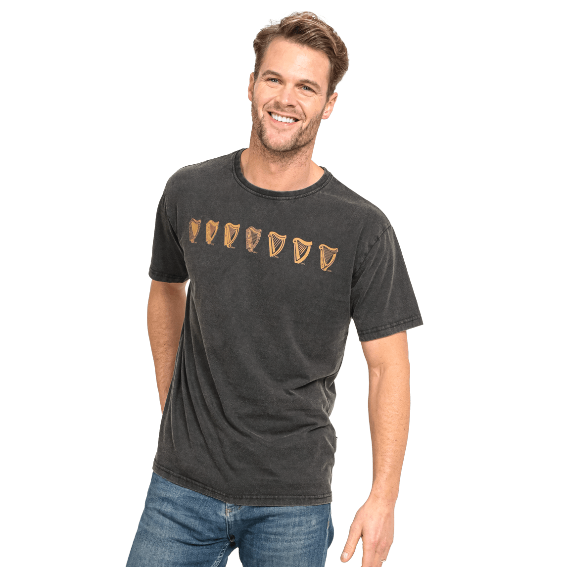 A man is smiling while wearing a black cotton t-shirt featuring the Guinness UK Evolution Harp Tee design.