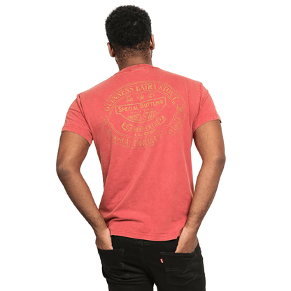 The back of a man wearing a Guinness UK Premium Harp Red T-shirt.