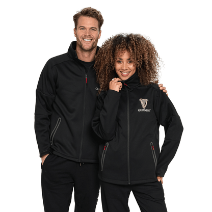 A man and woman posing for a photo in a Guinness UK waterproof jacket.