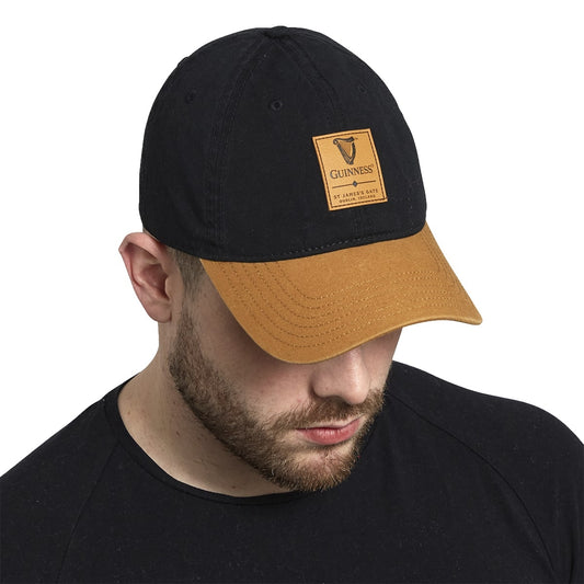 A man wearing a Guinness Premium Black & Camel with Leather Patch Cap by Guinness UK.