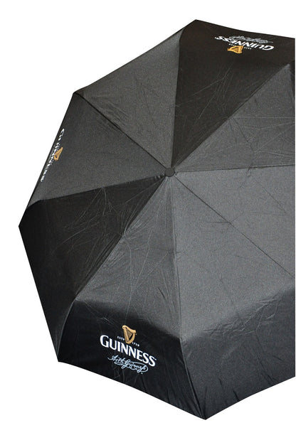 A black folding Guinness Gents Contemporary Umbrella with a Guinness logo, perfect for rainy days.