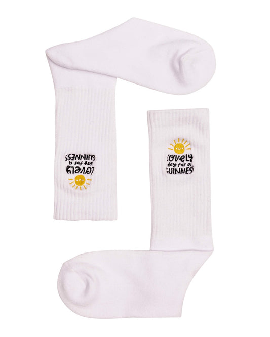A pair of FATTI BURKE "LOVELY DAY FOR A GUINNESS" white socks with a sun on them, perfect for a lovely day.