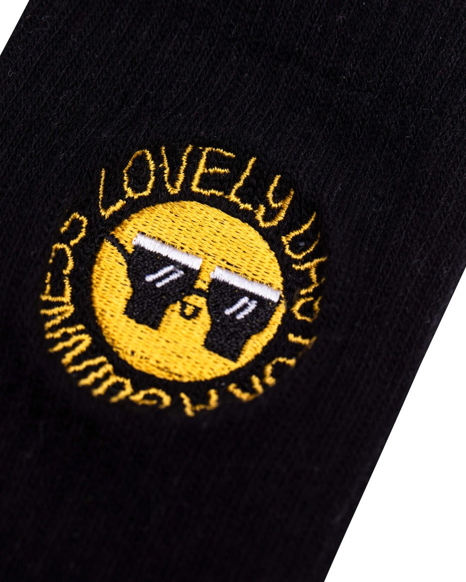 A stylish FATTI BURKE "LOVELY DAY FOR A GUINNESS" BLACK SOCKS with a smiley face on it. (Brand Name: Guinness Webstore UK)