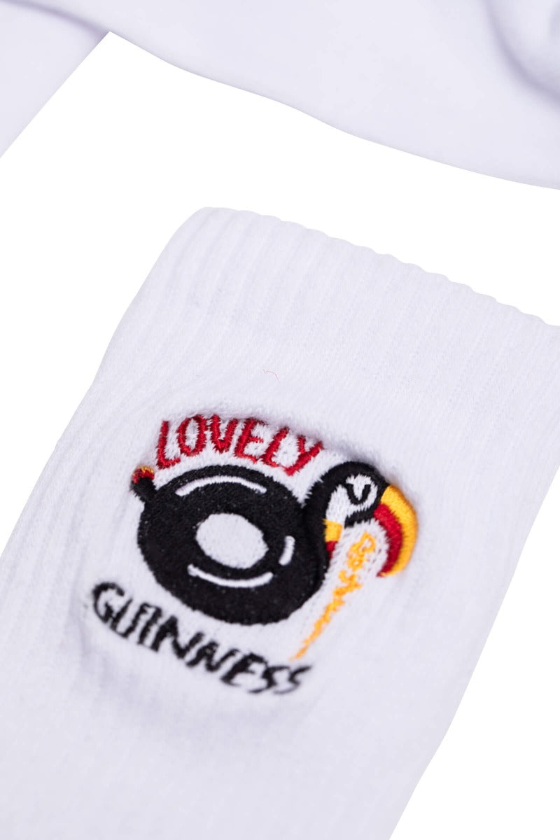 A pair of stylish FATTI BURKE "LOVELY DAY FOR A GUINNESS" TOUCAN white socks with a guinea pig logo on them by Guinness Webstore UK.