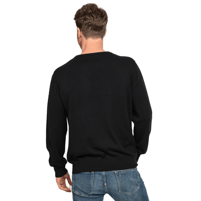 The back view of a man wearing a Guinness UK 100% Organic Cotton Jumper and jeans.