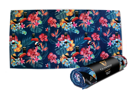 A Guinness Toucan Hawaiian beach towel with tropical flowers on it perfect for summer lounging. (Brand Name: Guinness UK)