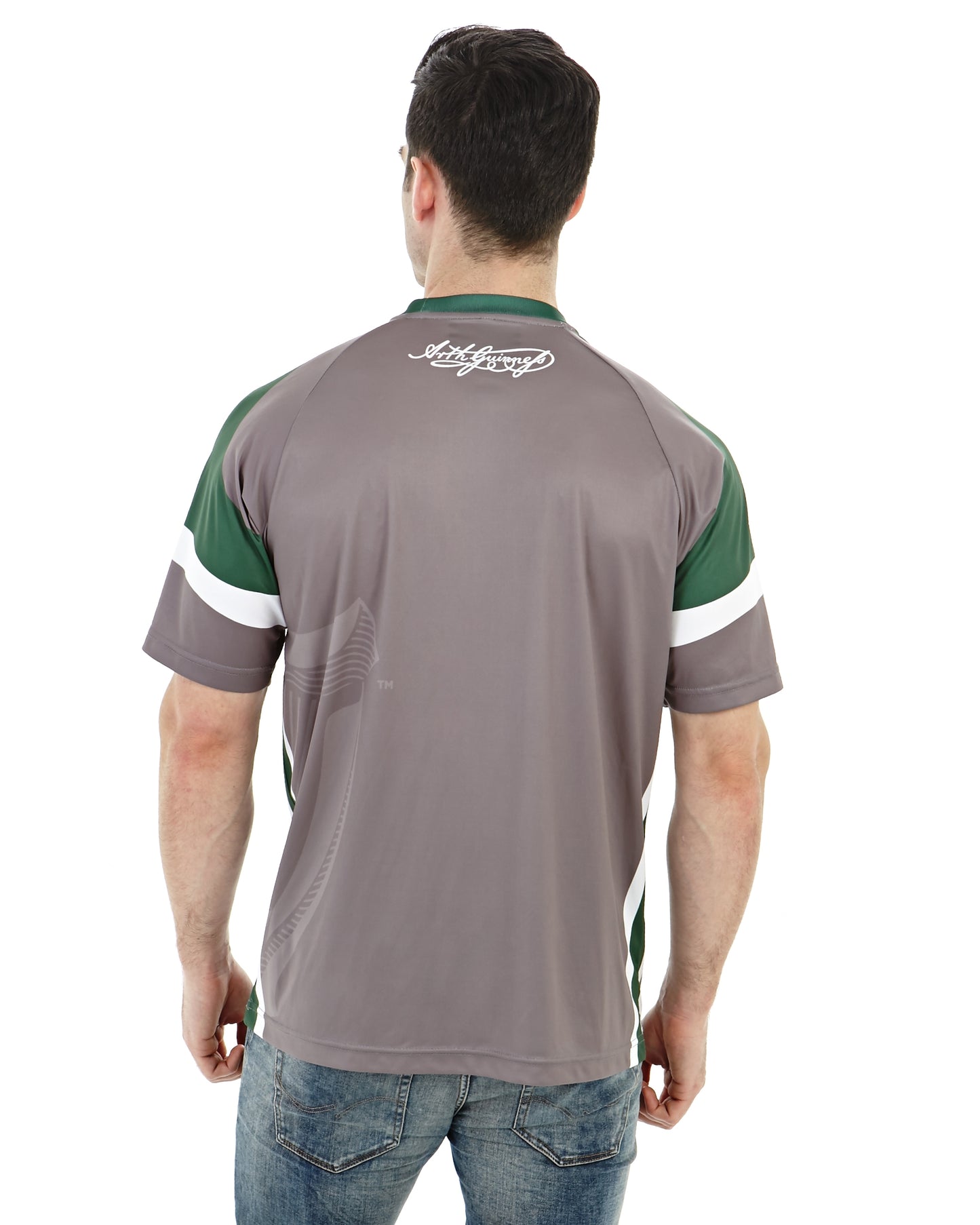 The back of a Guinness® soccer fan wearing a grey and green Guinness Performance Football Jersey.