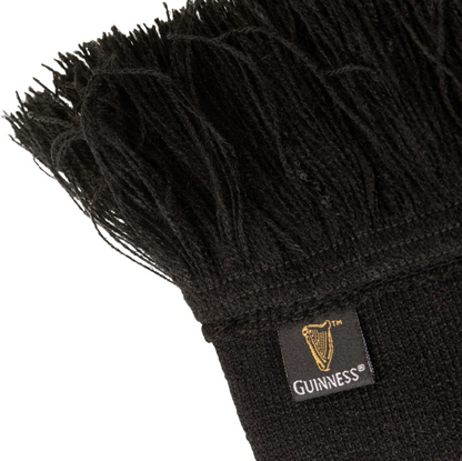 A black Guinness Six Nations scarf with fringes on it, perfect to show support during the Six Nations rugby matches.