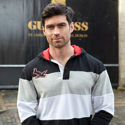A hooded man wearing a Guinness Black & Red Toucan Hooded Rugby hoodie from Guinness UK.