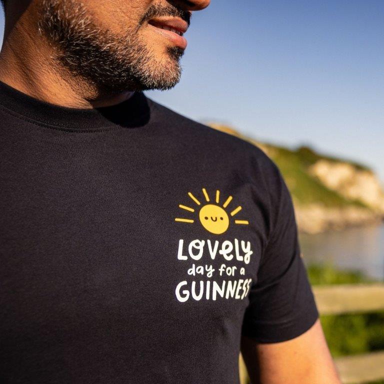 A man wearing a FATTI BURKE "LOVELY DAY FOR A GUINNESS" BLACK T-SHIRT from the Guinness Webstore UK Clothing & Accessories collection.
