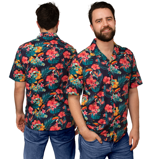 A man wearing a Guinness UK Guinness Toucan Hawaiian Shirt adorned with tropical plants and flowers.