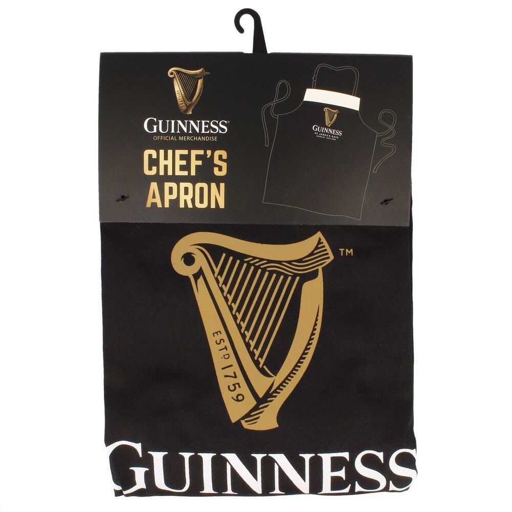 The Guinness Pint Apron, a black chef's apron crafted from 100% cotton, showcases a golden harp logo and the "Guinness" text. Packaged with a hanger, this apron is perfect for any Guinness enthusiast and brings to mind the classic Guinness pint while adding flair to your kitchen attire.