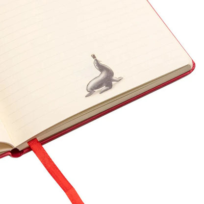 Unveil the classic Guinness Gilroy Toucan Notebook, featuring lined pages and a distinctive silver seal-shaped paperclip. A red ribbon bookmark adds a touch of elegance to this notebook from the Guinness Webstore UK, highlighting its design inspired by the renowned Gilroy Toucan.