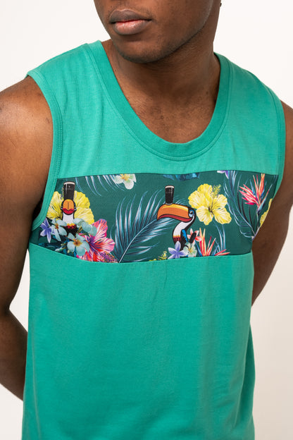 Wearing the Guinness Toucan Hawaiian Green Tank from Guinness Webstore UK, with its sleeveless teal style and vibrant chest panel of flowers and toucans, brings tropical paradise vibes.