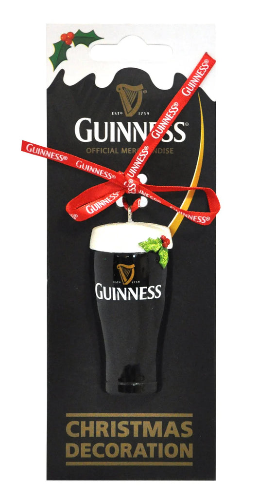 The Guinness Christmas Decoration - Pint captures the essence of the Guinness brand by showcasing a beer pint adorned with a red ribbon and holly. The decoration is elegantly packaged on a branded display card, featuring the iconic toucan to enhance its classic charm.