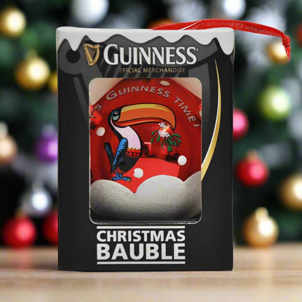 The Guinness Christmas Toucan Bauble, with its vibrant red design featuring the iconic Guinness Toucan, comes elegantly packaged in a sleek black box labeled "Guinness Official Merchandise." It's perfect for adding a touch of whimsy to your Guinness Christmas tree decoration.