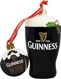 A pair of Guinness Christmas ornaments: one is the Guinness Christmas Glass Decoration Pint featuring a red ribbon, and the other is a round resin bauble adorned with festive designs.