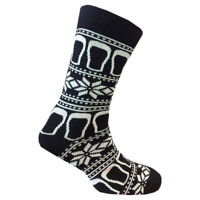 These socks, known as the Guinness Black & White Pint Socks from the Guinness Webstore UK, feature a blend of white geometric and snowflake patterns on a black base, perfectly capturing the festive spirit with a hint of Irish charm.